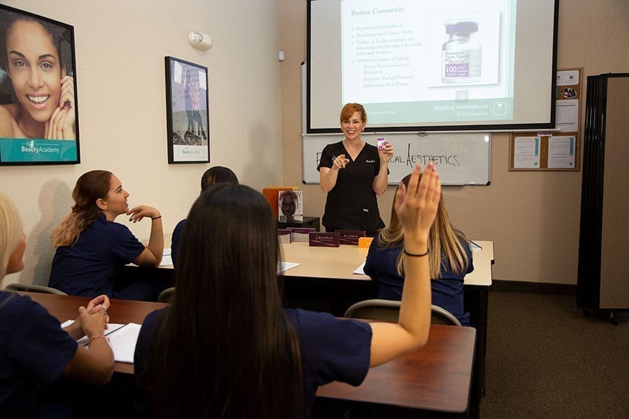 Aestheticians in class learning how to improve visibility and brand awareness for their medical aesthetician business