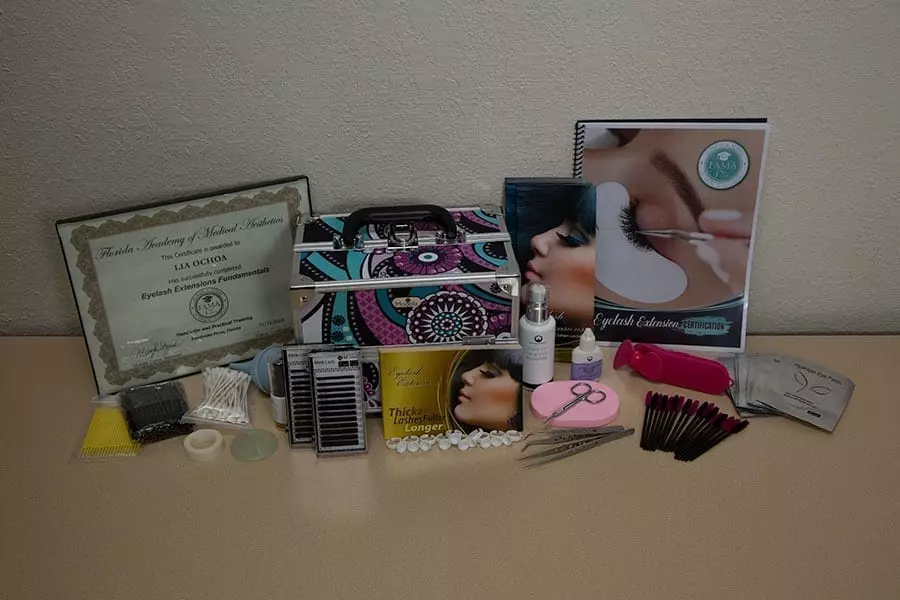 FAMA eyelash extension training kit with certificate, tools, and course materials