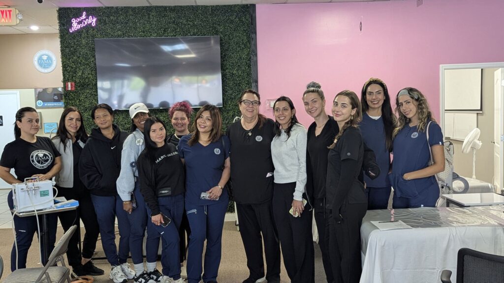 FAMA instructor and students posing together in the training clinic