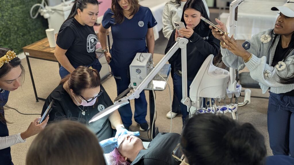 FAMA instructor demonstrating a treatment technique while students record on their phones