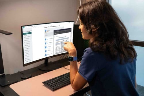 FAMA student completing online coursework at a computer