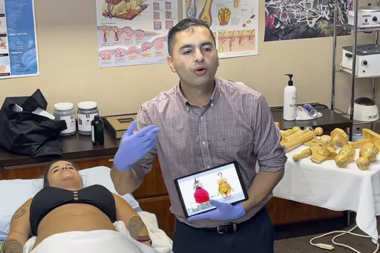 FAMA instructor teaching a wood therapy lesson with before-and-after photos on a tablet