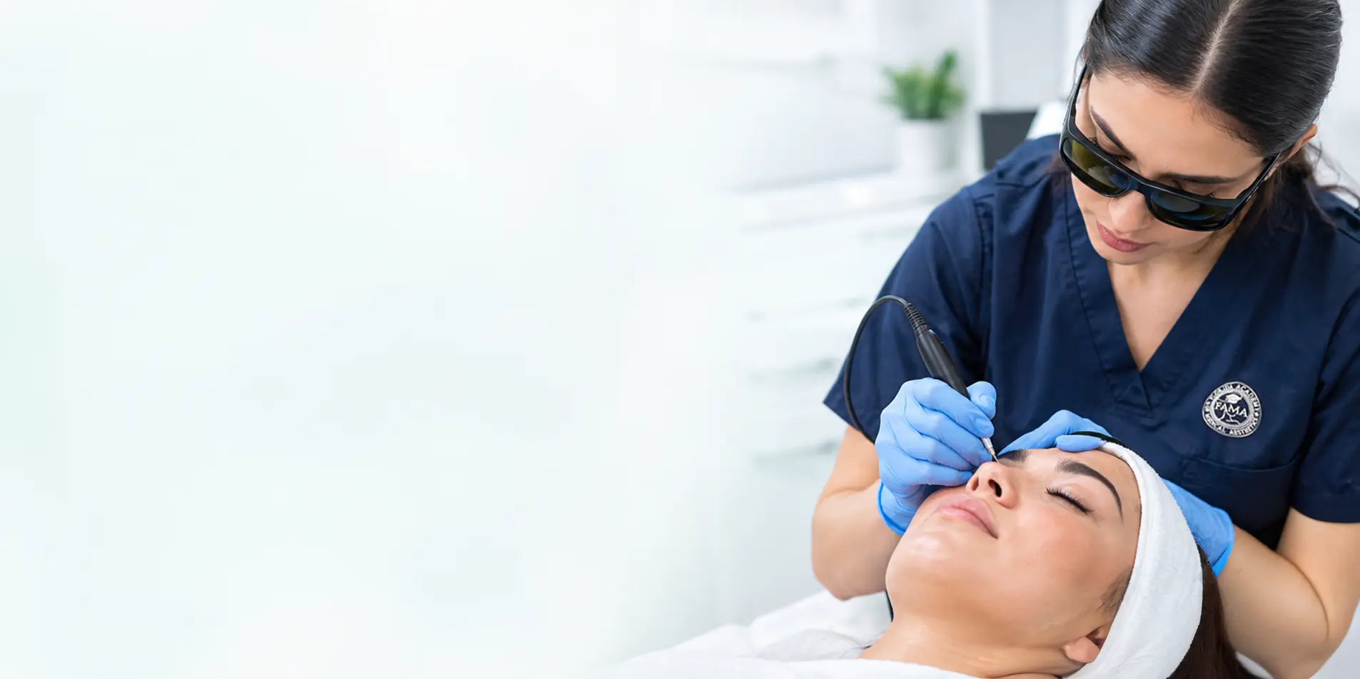 Licensed electrologist performing facial electrolysis hair removal on a client during hands-on training at FAMA Academy in Florida